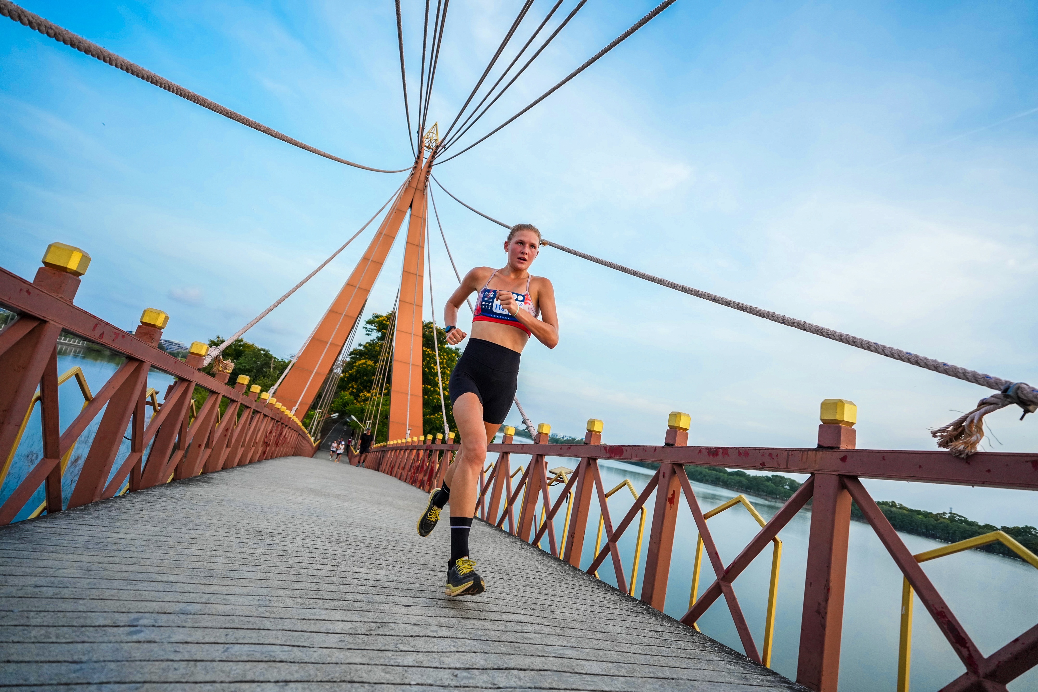 Kiana running across a bridge during an international race